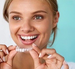A woman about to place a teeth whitening tray