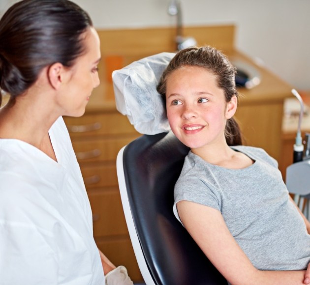 Young patient smiling during children's dentistry checkup and teeth cleaning visit