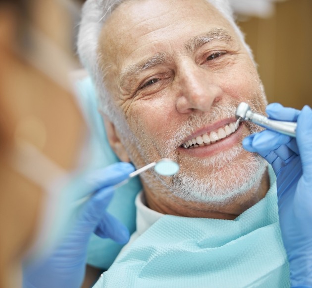 Man receiving dental checkup to protect his gum health