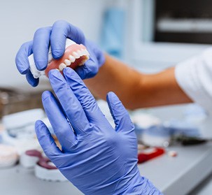 a dental lab technician crafting a denture