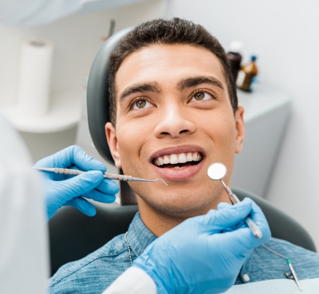 Man receiving checkup to prevent dental emergencies