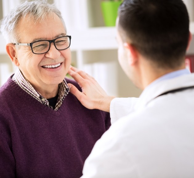 Patient talking to dentist about the dental implant retained dentures procuedure