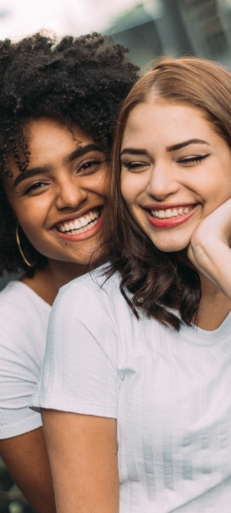 Two women with flawless smiles after cosmetic dentistry