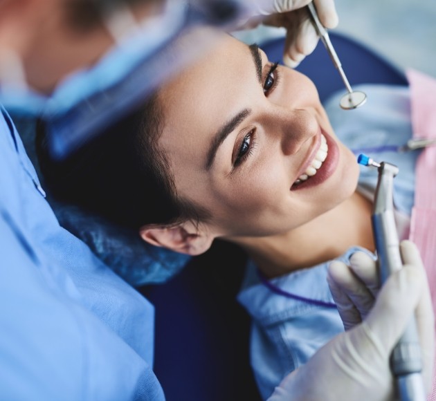 Dentist examining patient after Invisalign treatment