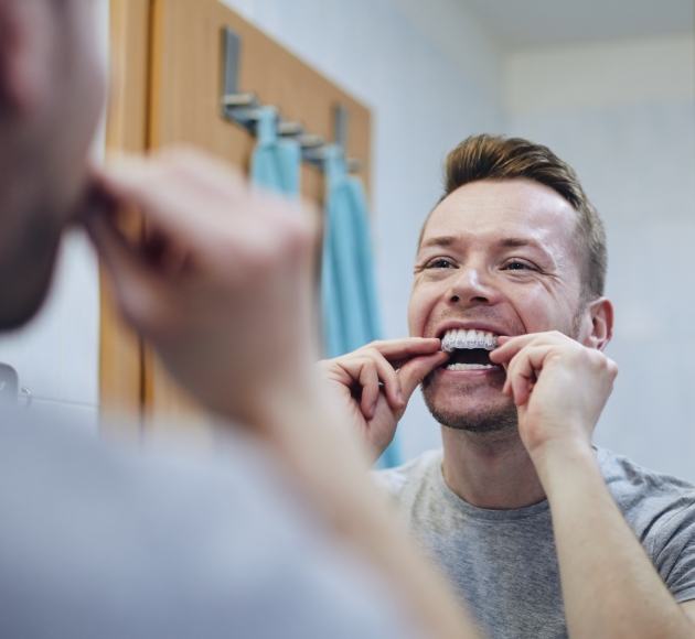 Man placing his Invisalign tray