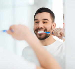a man brushing his teeth