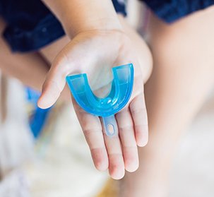 closeup of person holding a mouthguard