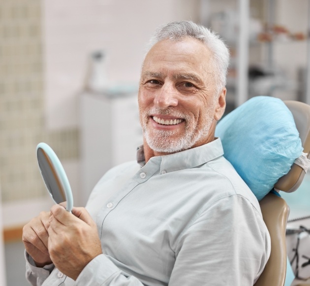 Man smiling after full mouth reconstruction