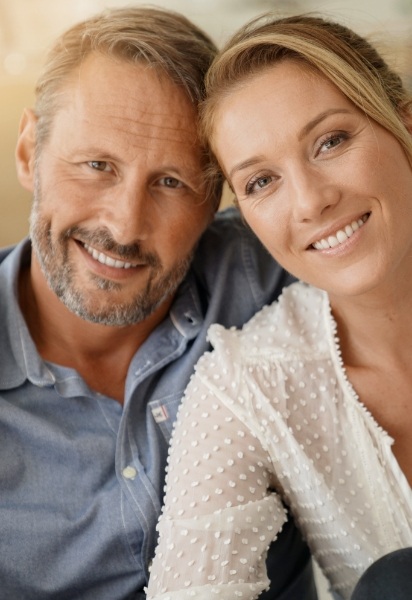 Man and woman smiling after restorative dentistry visit