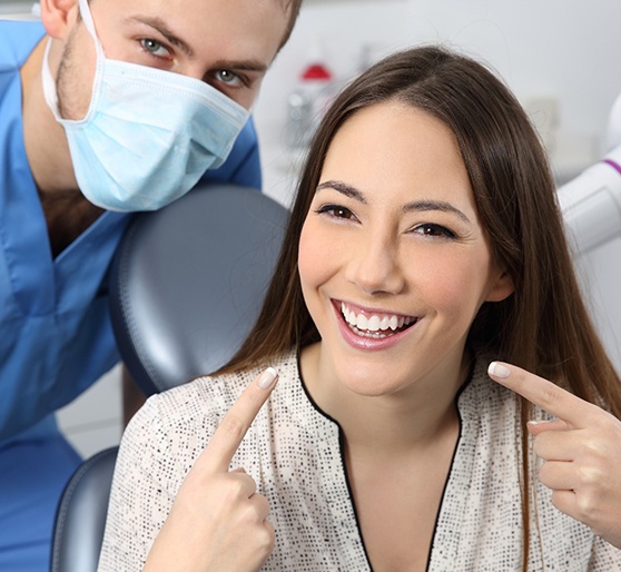 a patient smiling after undergoing teeth whitening in Natick