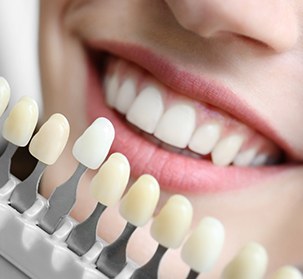 A young woman picking the ideal shade for her whitening treatment