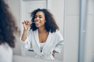 woman with diabetes brushing her teeth 