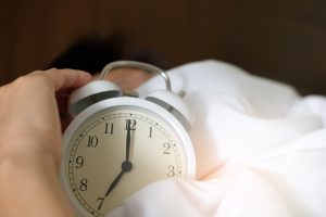 Old alarm clock on bed