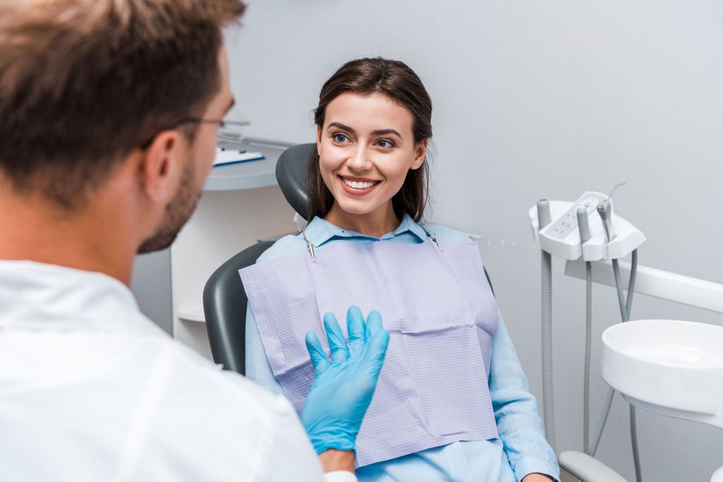 dentist speaking to patient at dental implant consultation