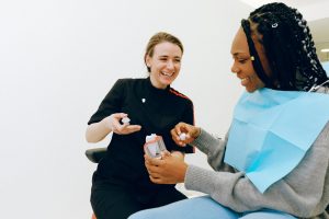 Dentist discussing dental crown with female patient